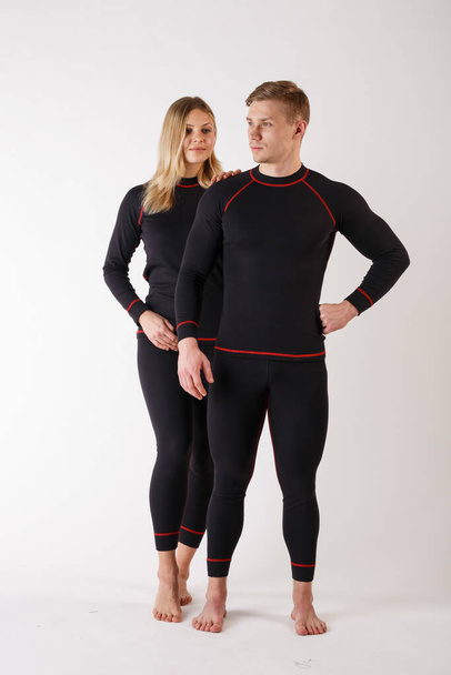 Guy and girl in thermal underwear on a white background - Photo, Image