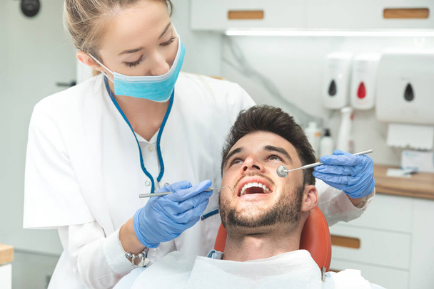 Man having teeth examined at dentists. Overview of dental caries prevention - Valokuva, kuva