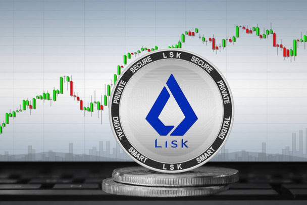 Криптовалюта Lisk (LSK); монета Lisk на задньому плані діаграми - Фото, зображення