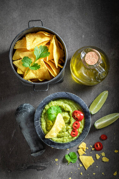 Homemade guacamole served with crackers, coriander and sunflower seeds - Fotografie, Obrázek