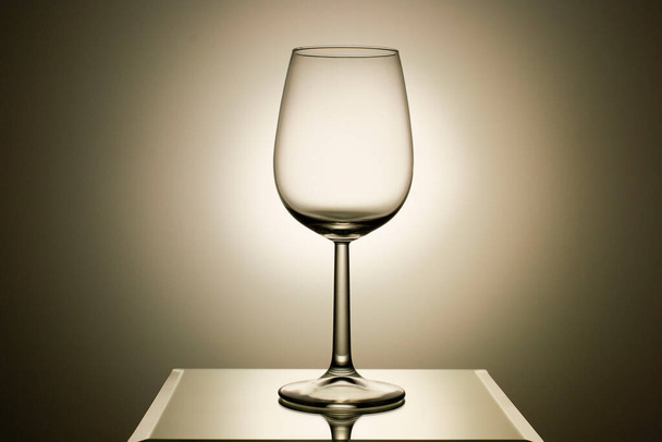 Empty wine glass on a light-gray background. Drink concept. - Foto, afbeelding