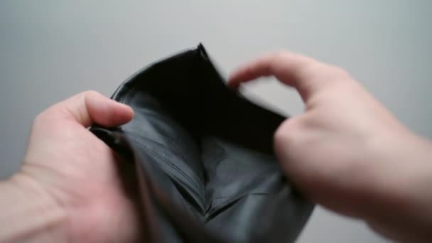 Total unemployment in period of financial crisis, male opening black leather wallet, empty wallet and no paper currency. Wallet with changes inside, bankruptcy and poverty concept - Footage, Video