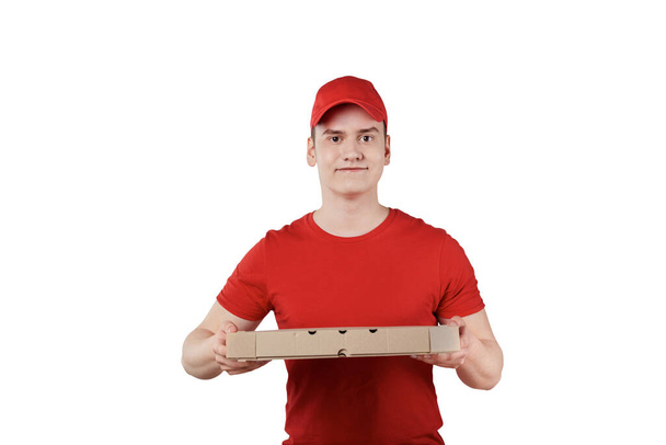 The delivery guy is holding a box of pizza in his hands - 写真・画像