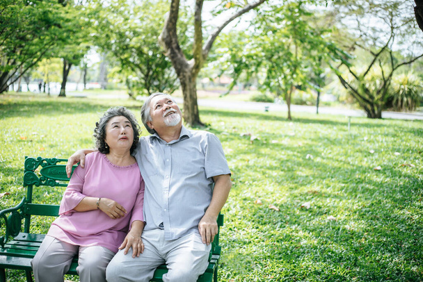 terve vanhempi pari rentouttava paikkaa penkillä puistossa - Valokuva, kuva