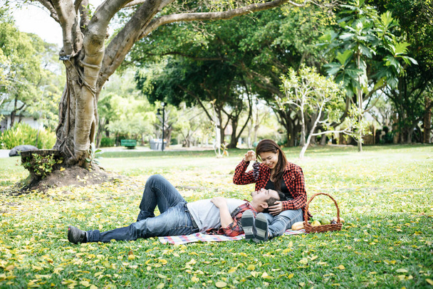 Romantic Young Couple Sitting In Garden - Foto, imagen
