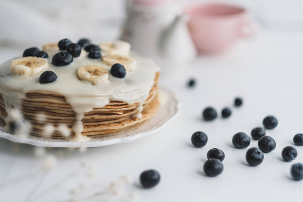 Pancakes with condensed milk with fresh blueberries and banana. - Φωτογραφία, εικόνα
