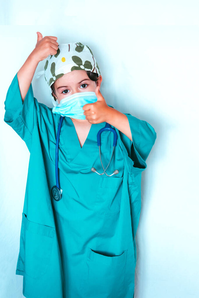 cute kid playing doctor dressed as a surgeon - Photo, Image