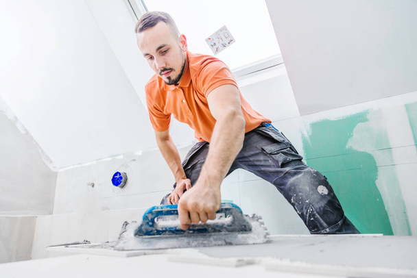professional worker repairing floor on construction site - Fotó, kép