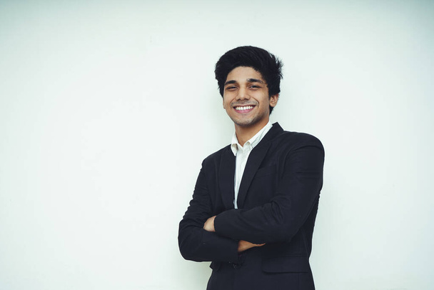 Portrait of a Young Handsome Asian Business man wearing black coat and white shirt standing in front of a white background, smiling and looking into the camera, - Fotoğraf, Görsel