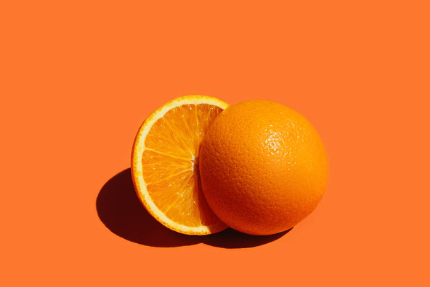 Round orang slice isolate on colorful background. - 写真・画像
