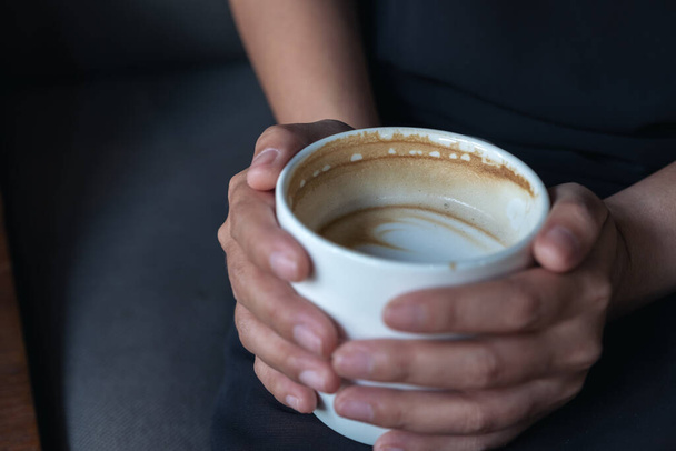 Крупним планом зображення рук жінки, що тримає білу чашку гарячої кави
  - Фото, зображення