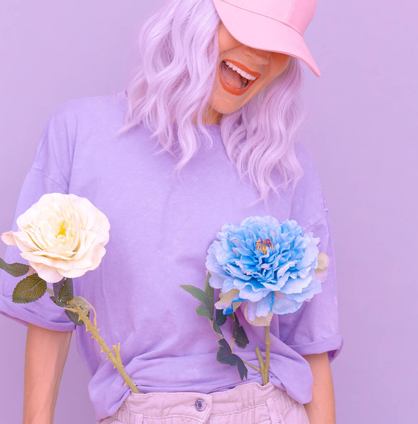 Happy Stylish summer girl with flowers in trendy b-boy cap. Pastel colours design - Фото, изображение