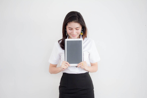 Portrait of thai adult beautiful girl white shirt show her tablet. - Foto, afbeelding