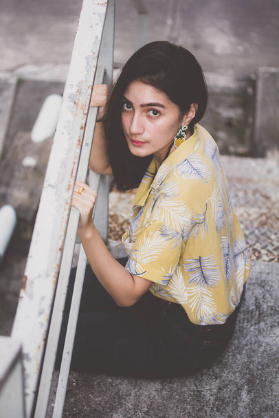Portrait of thai yellow shirt adult beautiful girl relax time, in Vintage Style - Foto, afbeelding