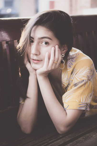 Portrait of thai yellow shirt adult beautiful girl relax time, in Vintage Style - Photo, Image