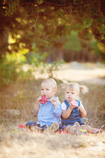 Cute boy and girl playing together summer outdoors - Foto, afbeelding