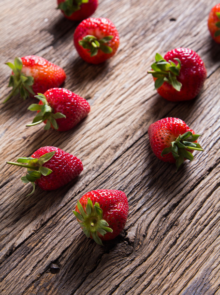 Strawberries on old wooden background - Фото, изображение