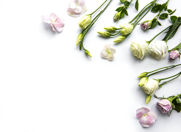 Framework from flowers on white background. Flat lay. - Foto, imagen