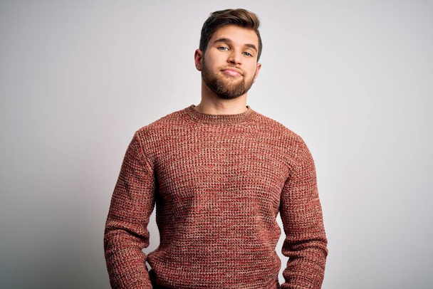 Young blond man with beard and blue eyes wearing casual sweater over white background looking sleepy and tired, exhausted for fatigue and hangover, lazy eyes in the morning. - Photo, Image