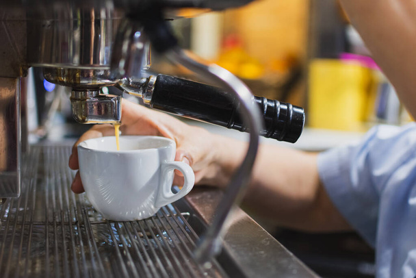 close up of waitress making coffee in the coffee machine - Foto, immagini