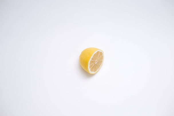 Cut lemon on white surface - Foto, imagen