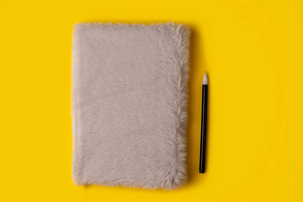notebook,pen, on yellow background. top view copy space - Φωτογραφία, εικόνα