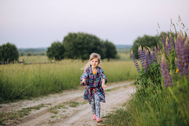 Young girl running in summer field - Фото, изображение