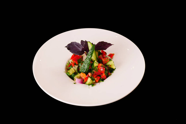 Choban salad. Cucumber and tomato salad with greens. Black background - Fotoğraf, Görsel