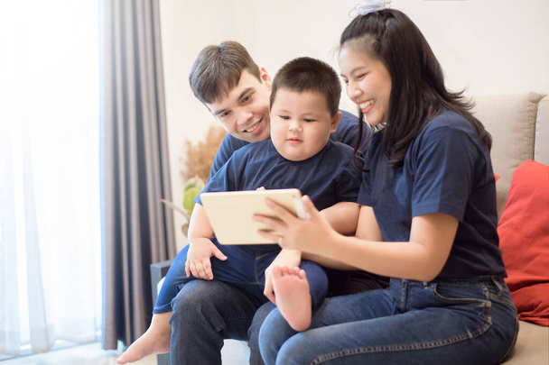 Happy family are enjoying on sofa at home, Safety home activity concept  - Photo, Image