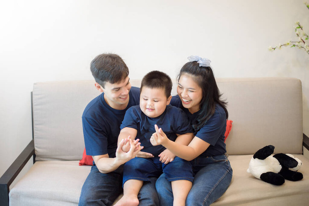 Happy family are enjoying on sofa at home, Safety home activity concept  - Photo, image