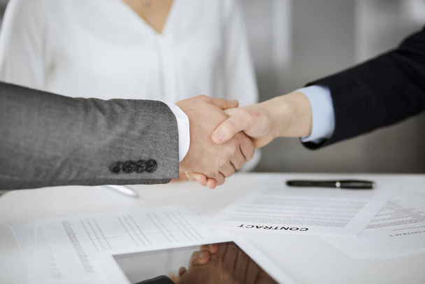 Business people shaking hands finishing contract signing, close-up. Business communication concept. Handshake and marketing - Фото, изображение
