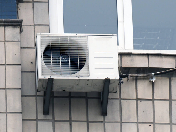old outdoor air conditioning unit on the facade of the house - Photo, Image