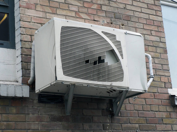 old outdoor air conditioning unit on the facade of the house - Photo, Image