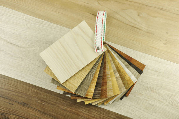 Wood laminate floor. Sample of laminate and vinyl tile on oak wooden background for new construction or renovate building or home. Venner. parquet - Photo, Image