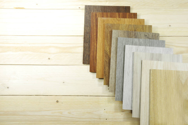 Wood laminate floor. Sample of laminate and vinyl tile on oak wooden background for new construction or renovate building or home. Venner. parquet - Photo, Image