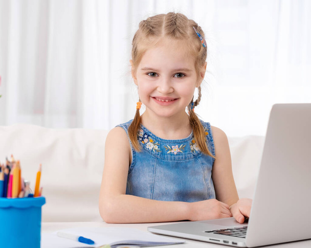 Little girl using her laptop - Photo, Image