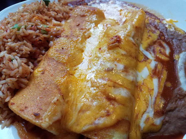 enchiladas with rice and beans and cheese on a plate - Photo, image