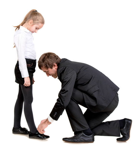 Father tying daughter's shoelaces - Foto, Bild