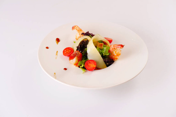 Salad with prawns, cheese, lettuce, tomatoes. White background - Zdjęcie, obraz