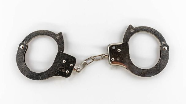 metal handcuffs on a white background, isolates - Photo, Image