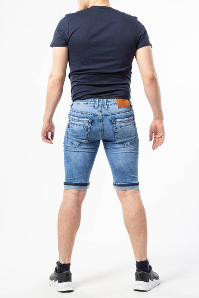 a man in denim shorts on a white background - Foto, Imagen