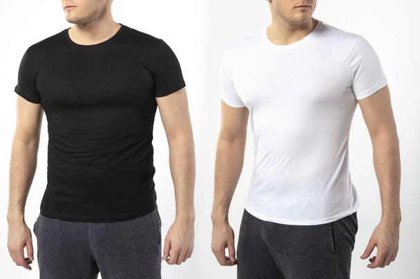 a man in a black and white t-shirt on a white background, t-shirt with a place for writing, copy space - Foto, afbeelding