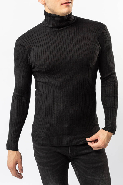 a man in a black turtleneck and black jeans on a white background, a black men's turtleneck close-up - Photo, Image