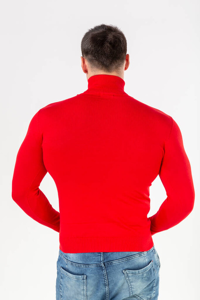 man in a red turtleneck with long sleeves on a white background, layout, copy of space - Fotó, kép