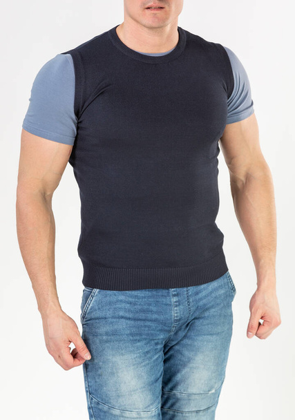 a man in a knitted vest and blue jeans on a white background - Photo, Image