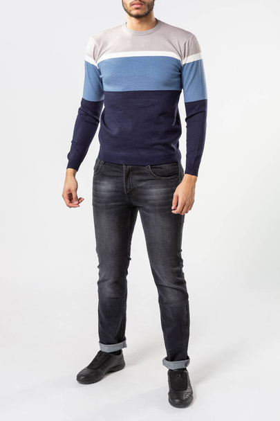 a man with a blue sweater and jeans on a white background - 写真・画像