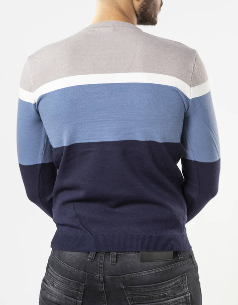 a man with a blue sweater and jeans on a white background - Foto, afbeelding