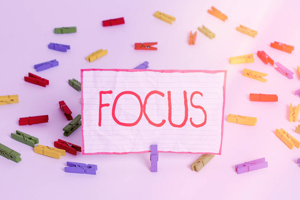 Conceptual hand writing showing Focus. Business photo text to give attention to one particular thing make do concentrate Colored clothespin papers empty reminder white floor office. - Photo, Image