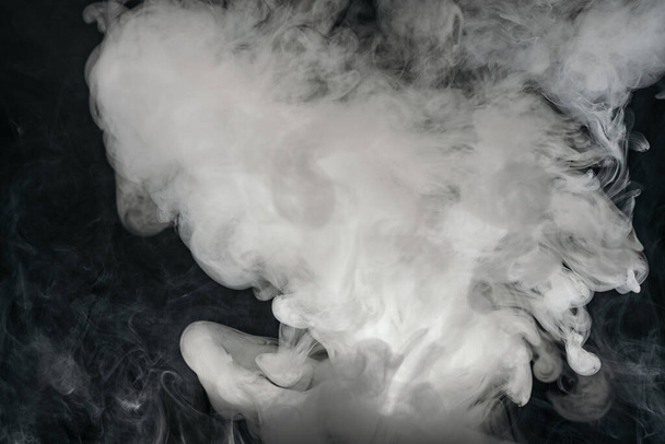 Smoke from a e-cigarette isolated on black background - Foto, Imagen