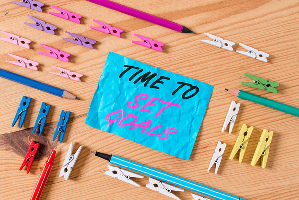 Conceptual hand writing showing Time To Set Goals. Business photo showcasing management tips Start training Eliminate bad habits Colored crumpled papers wooden floor background clothespin. - Photo, Image